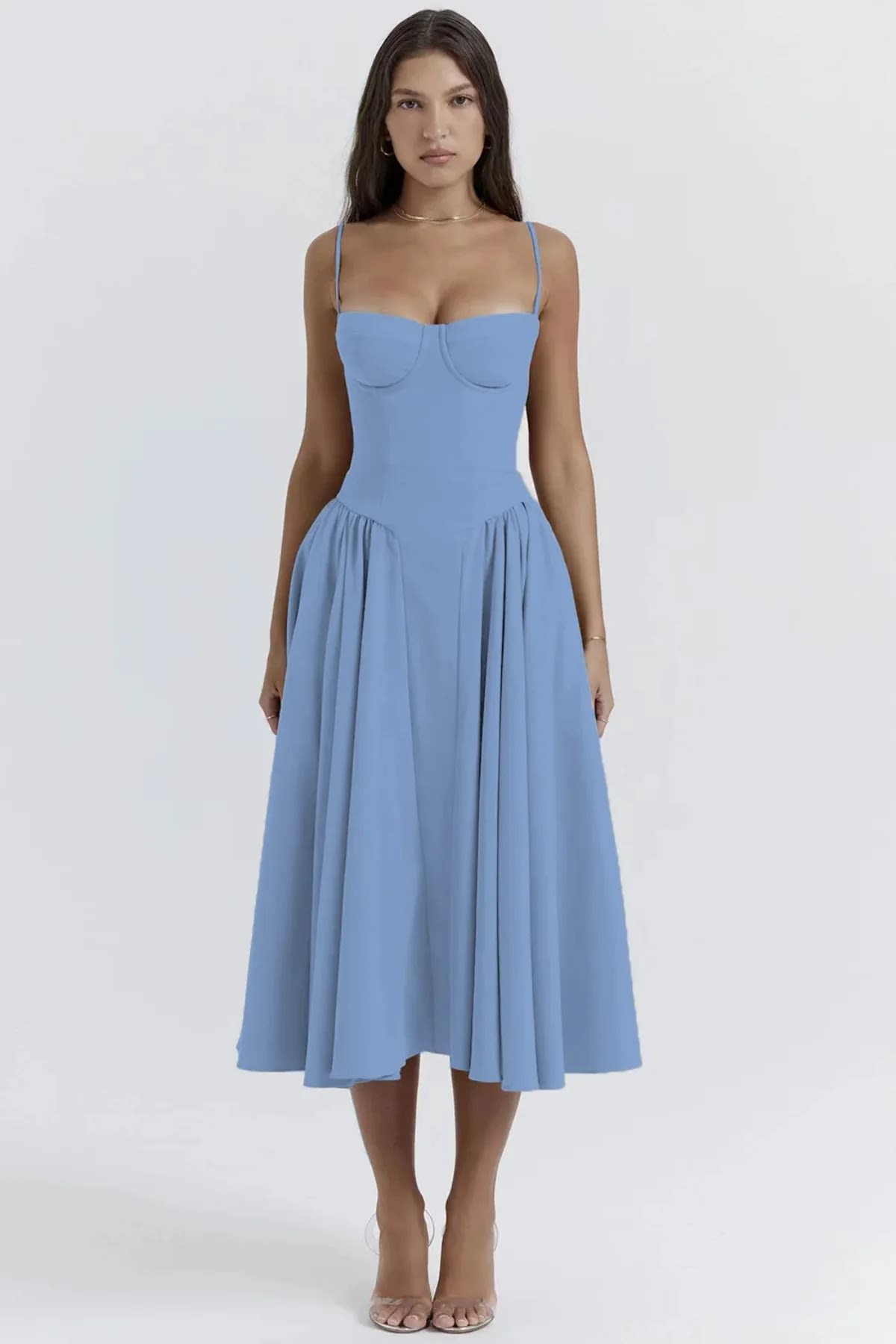 Woman wearing a bustier midi dress with spaghetti straps and A-line skirt.