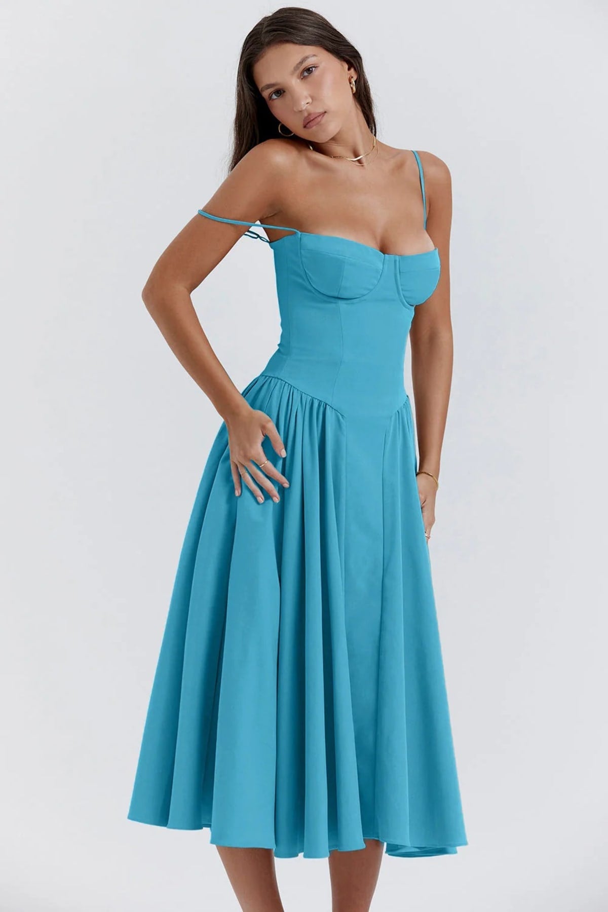 Woman wearing a bustier midi dress with spaghetti straps and A-line skirt.