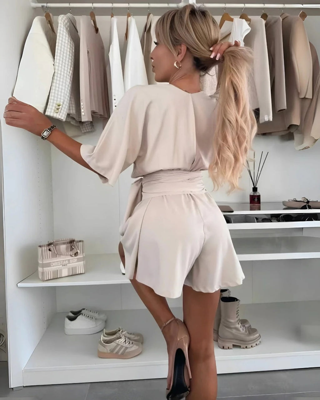 Fitted jumpsuit with bow belt and defined waistline.