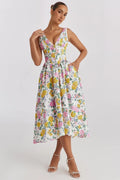 White midi dress with floral print, V-neckline, and pockets.