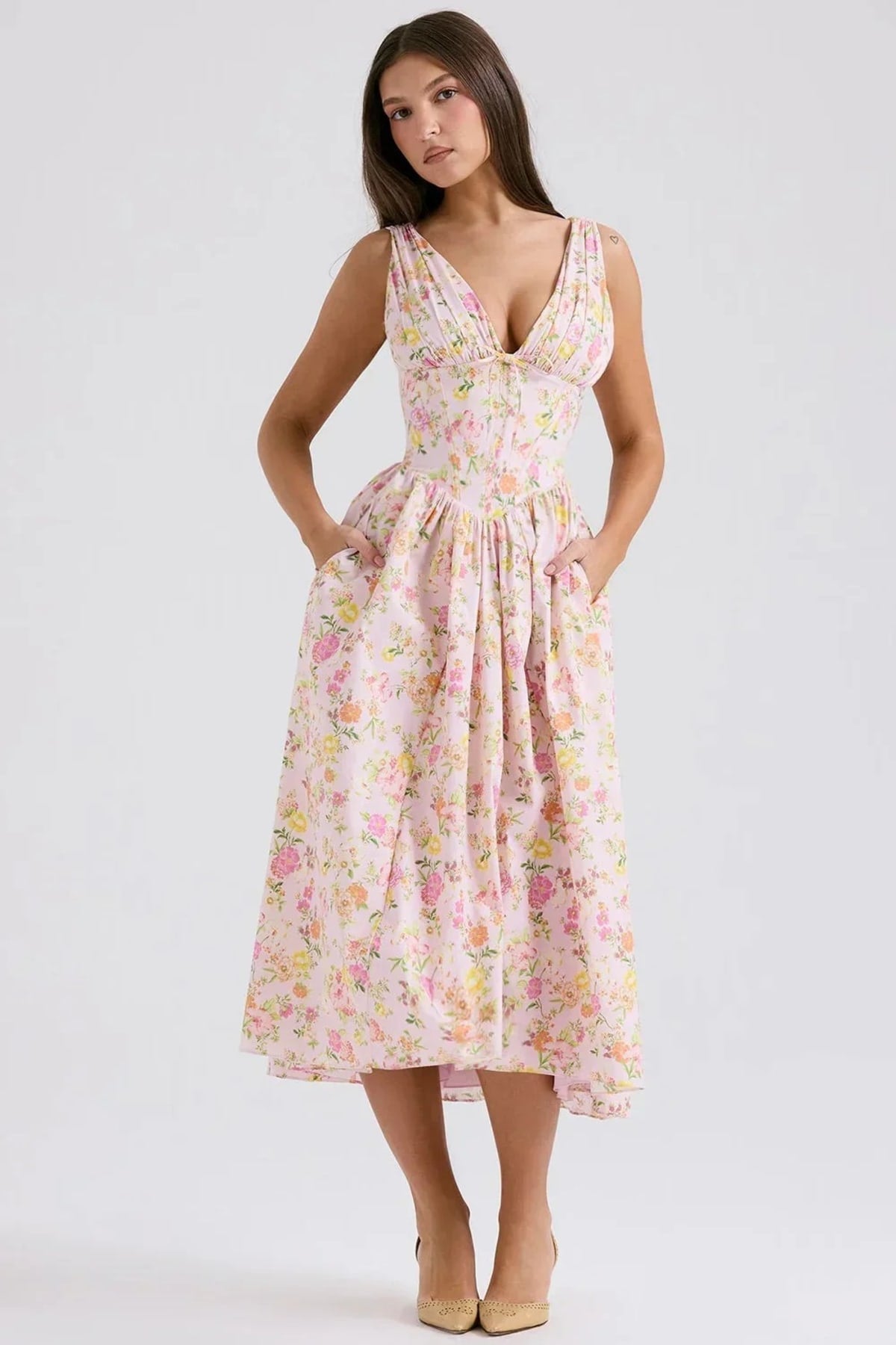 White midi dress with floral print, V-neckline, and pockets.
