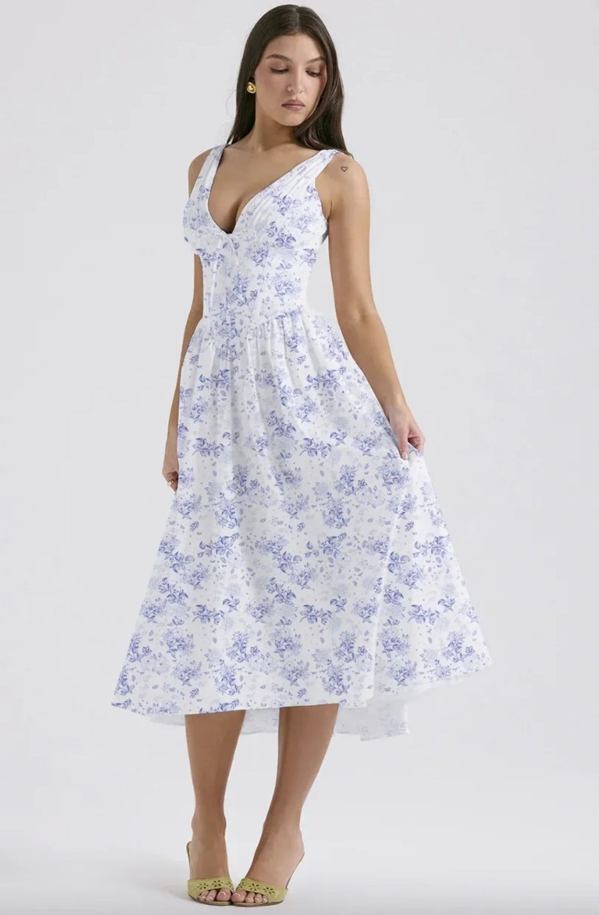 White midi dress with floral print, V-neckline, and pockets.
