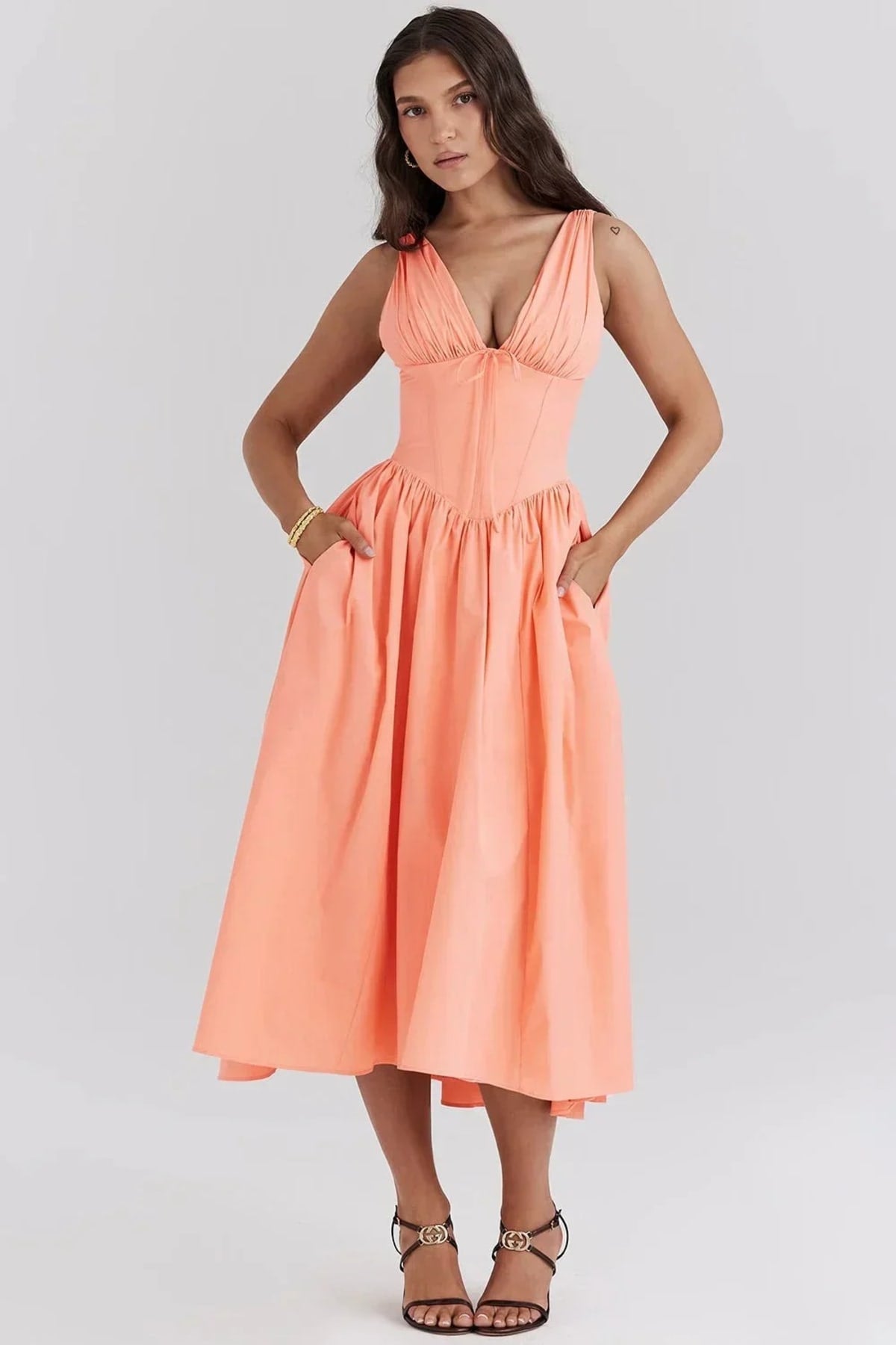 White midi dress with floral print, V-neckline, and pockets.