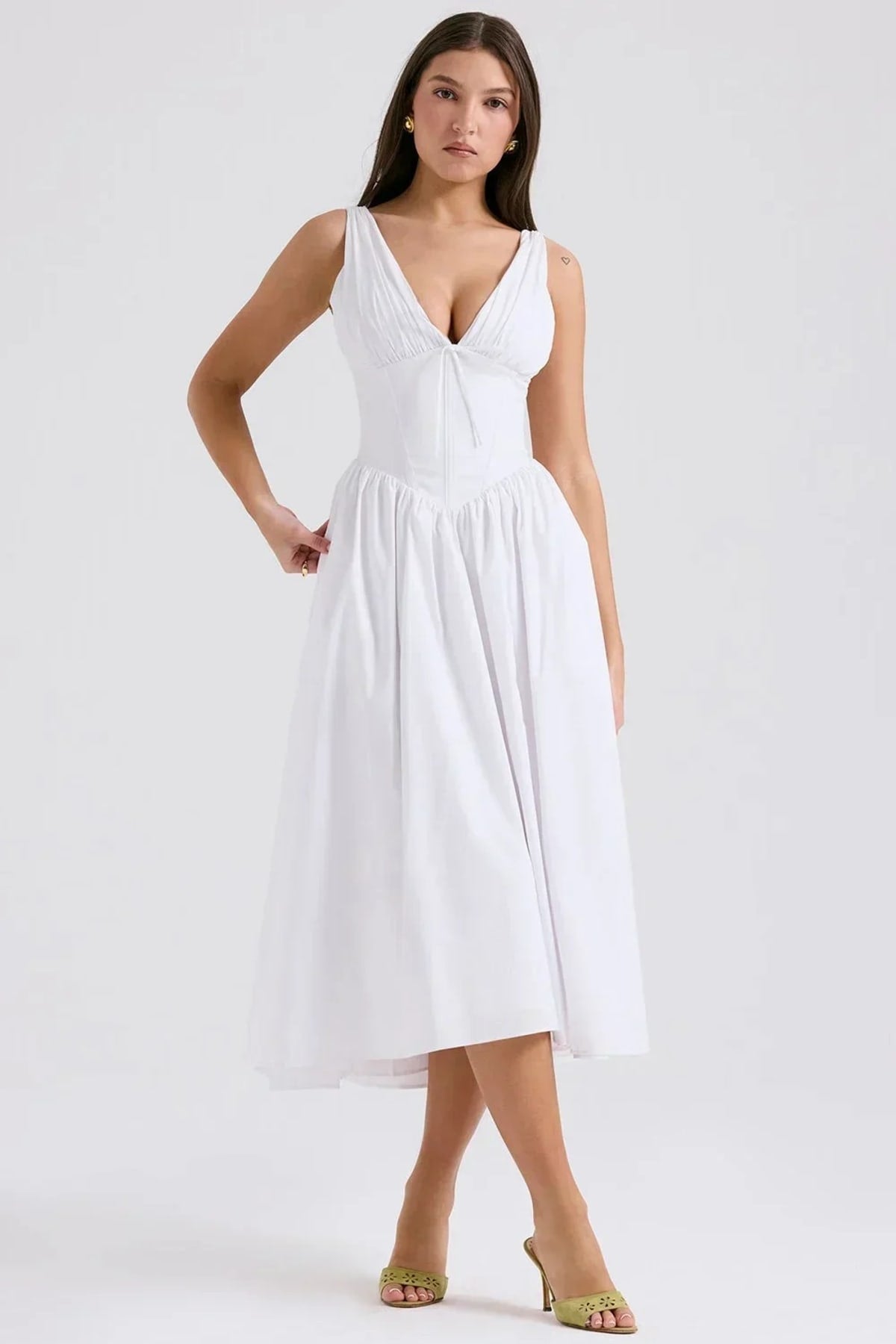 White midi dress with floral print, V-neckline, and pockets.