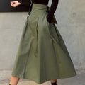 Woman wearing A-line midi wrap skirt with self-tie waist outdoors