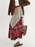Person wearing asymmetric layered maxi skirt with patchwork design