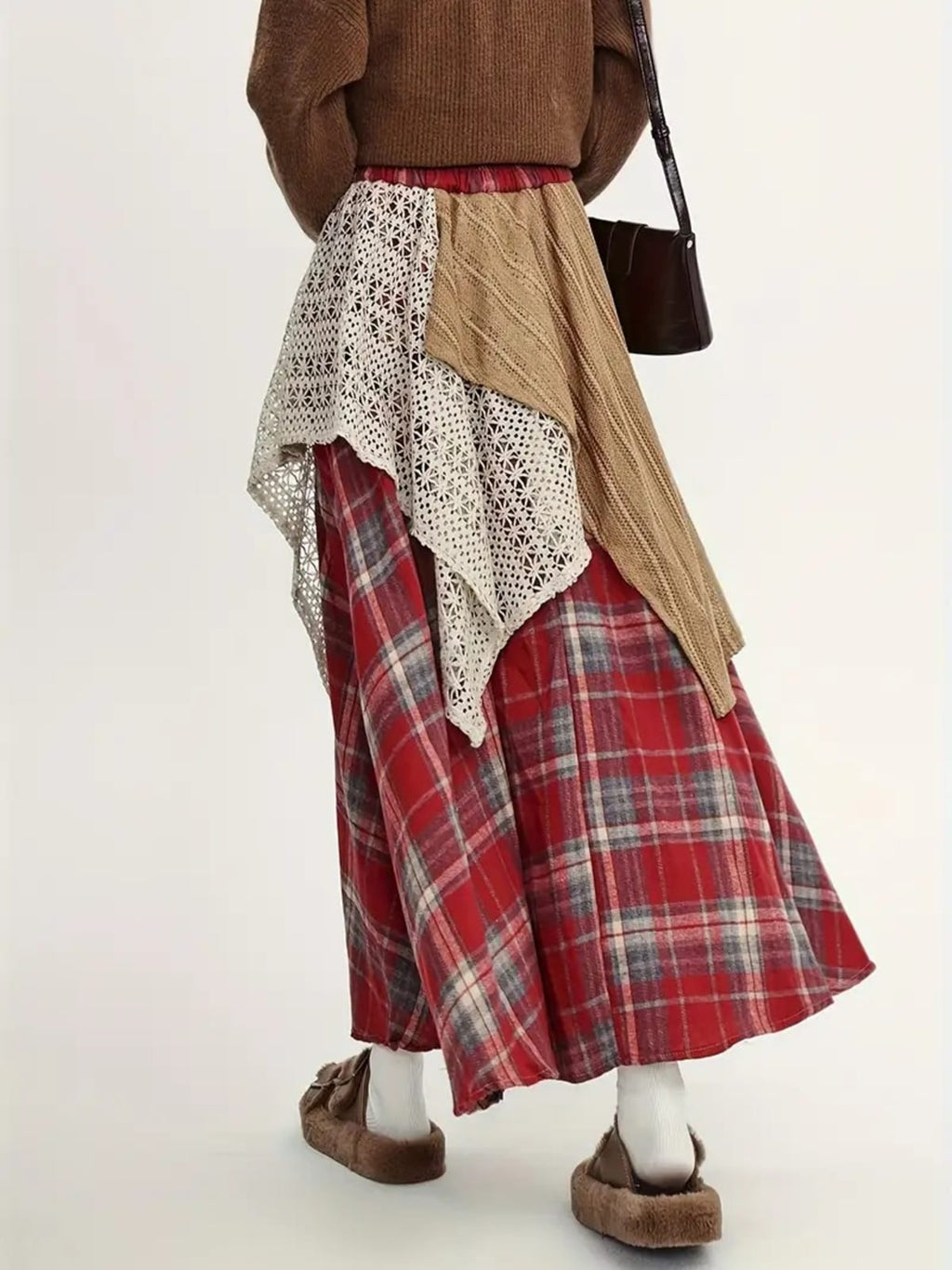 Person wearing asymmetric layered maxi skirt with patchwork design