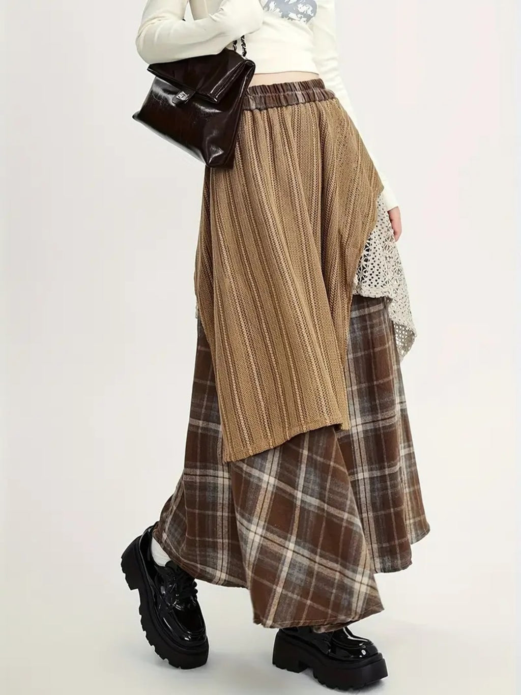 Person wearing asymmetric layered maxi skirt with patchwork design