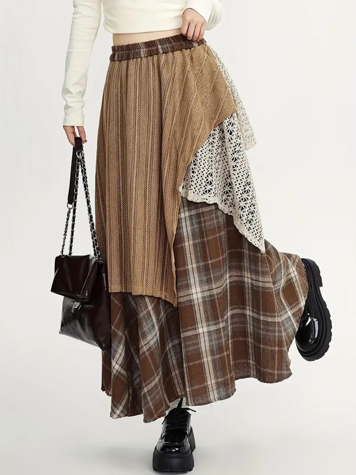 Person wearing asymmetric layered maxi skirt with patchwork design