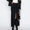 Woman wearing high-waisted denim maxi skirt with slit.