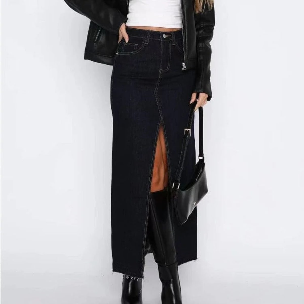 Woman wearing high-waisted denim maxi skirt with slit.