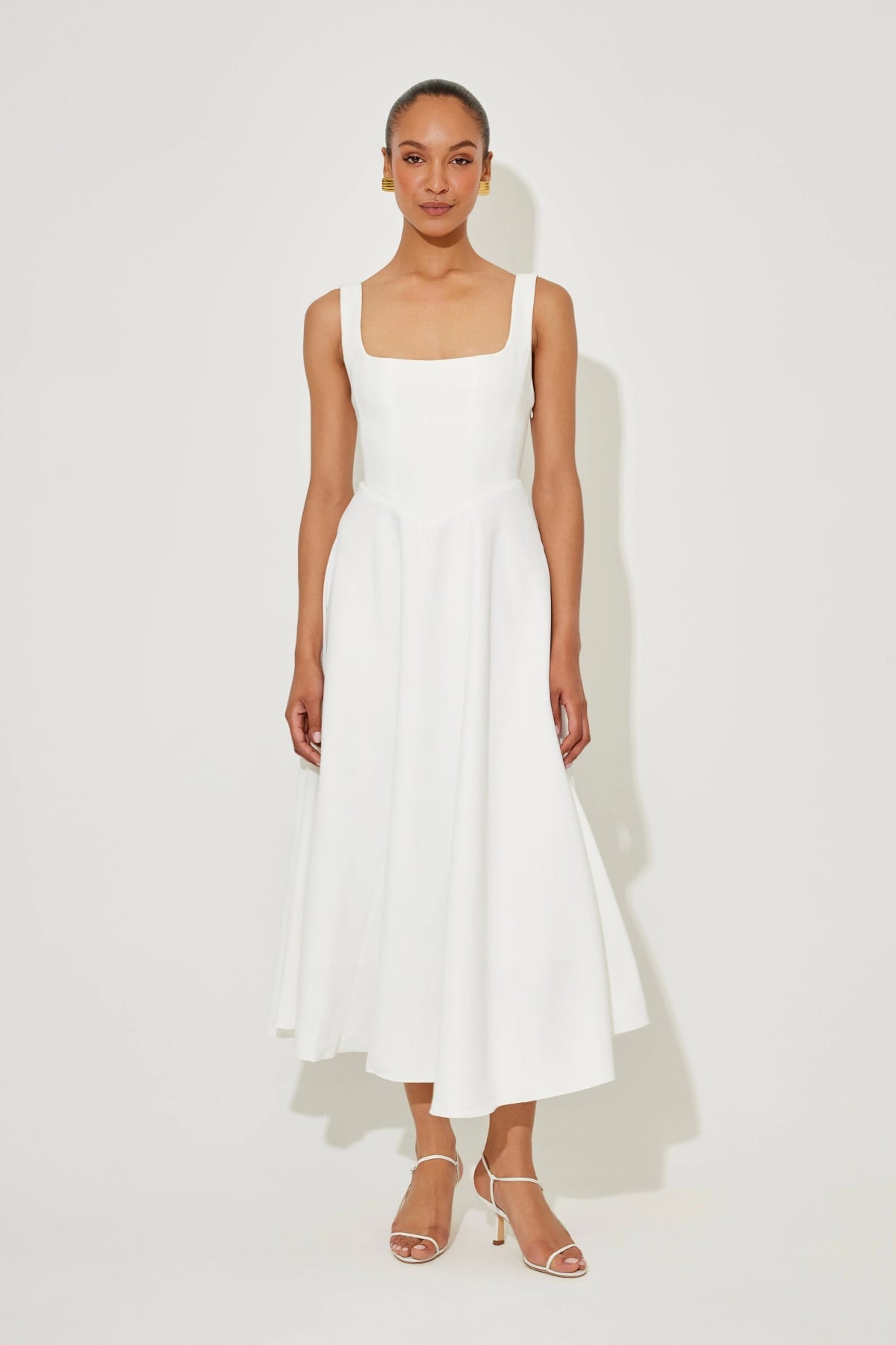 Square neck midi dress with waist-defining fit and flowing skirt.