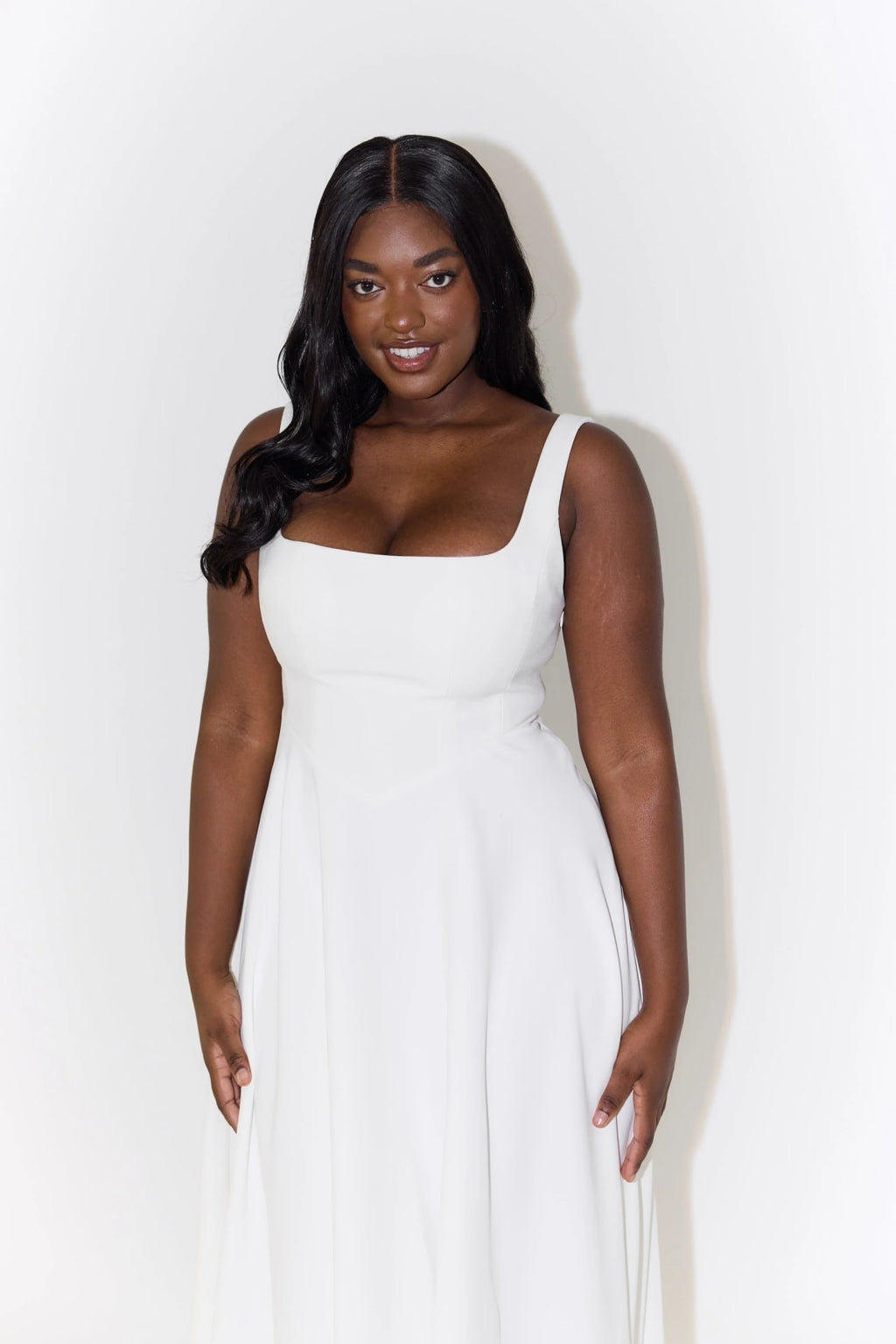 Square neck midi dress with waist-defining fit and flowing skirt.