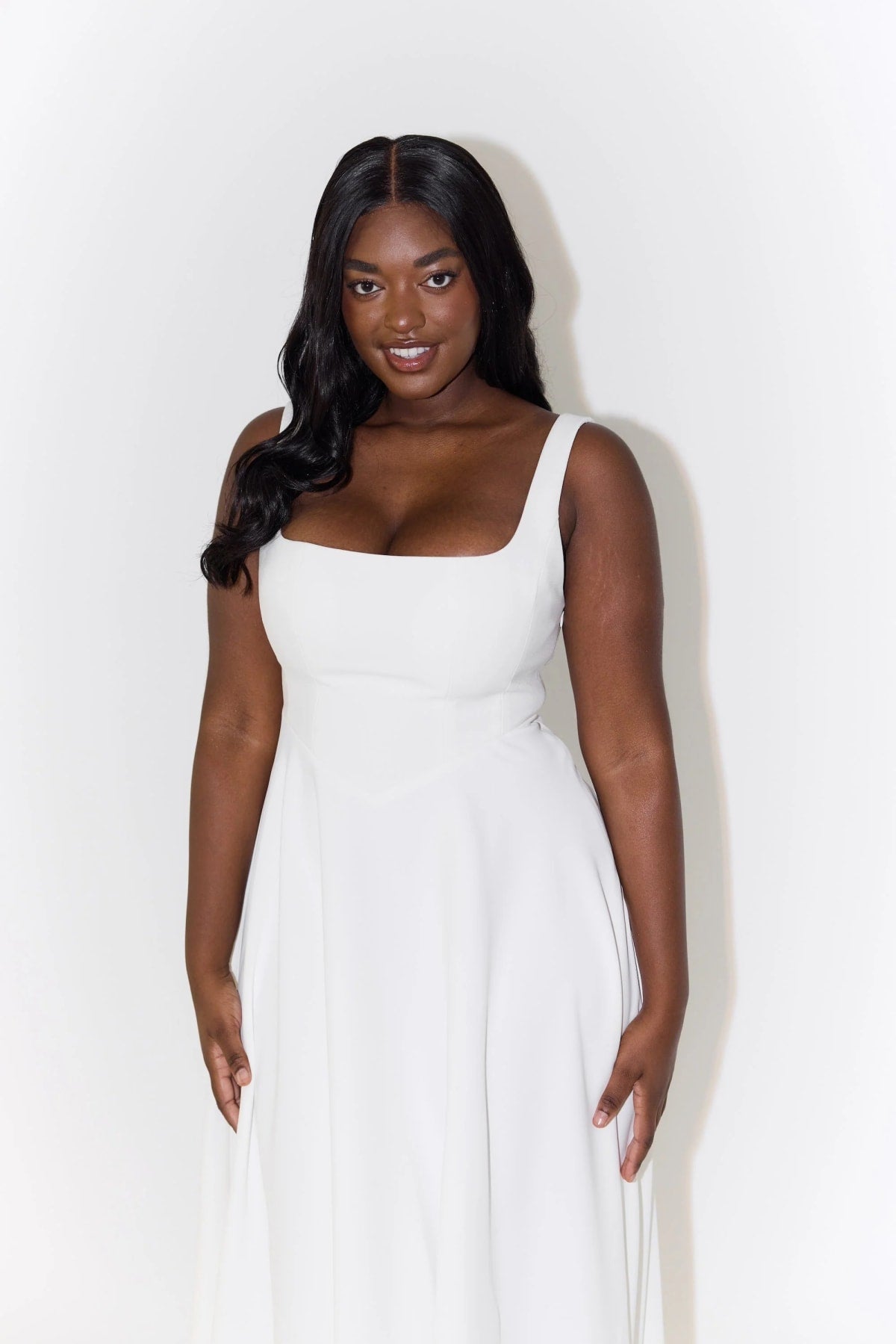 Square neck midi dress with waist-defining fit and flowing skirt.