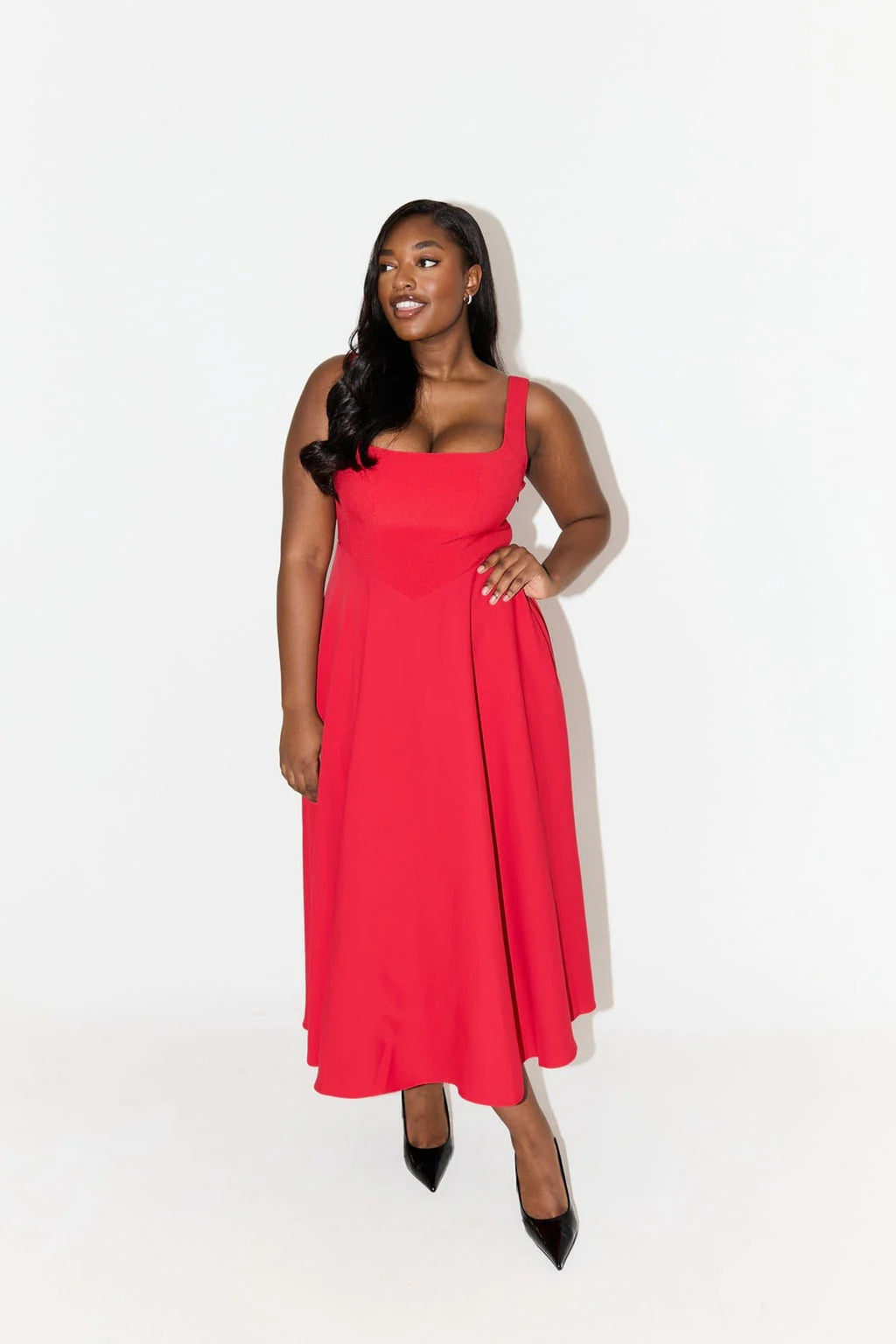 Square neck midi dress with waist-defining fit and flowing skirt.