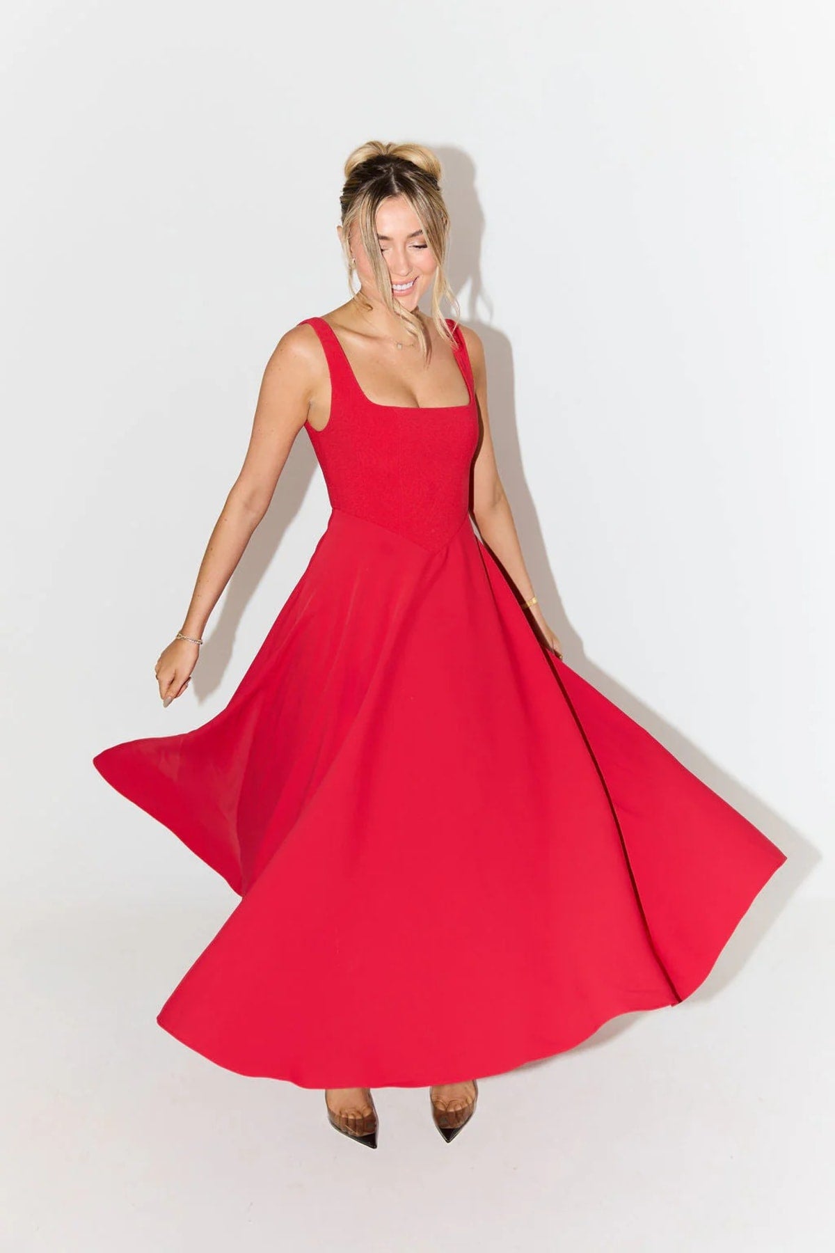 Square neck midi dress with waist-defining fit and flowing skirt.