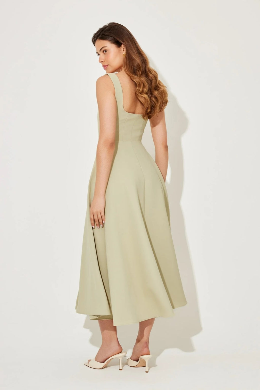 Square neck midi dress with waist-defining fit and flowing skirt.