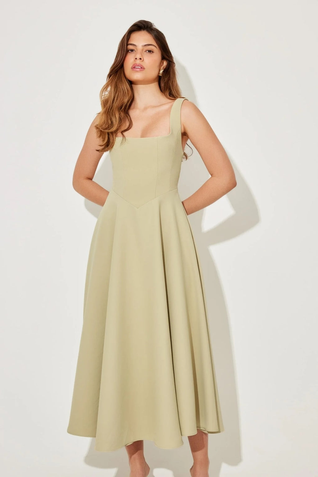 Square neck midi dress with waist-defining fit and flowing skirt.