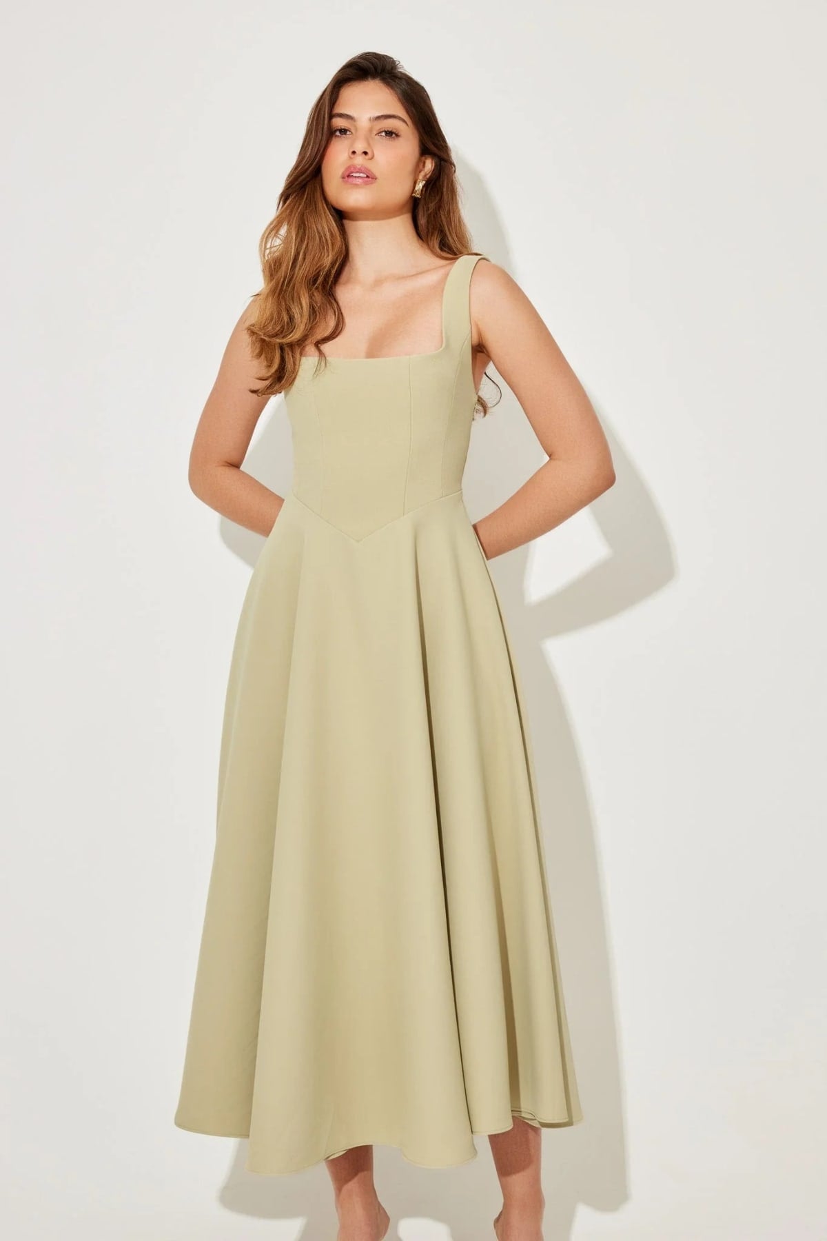 Square neck midi dress with waist-defining fit and flowing skirt.