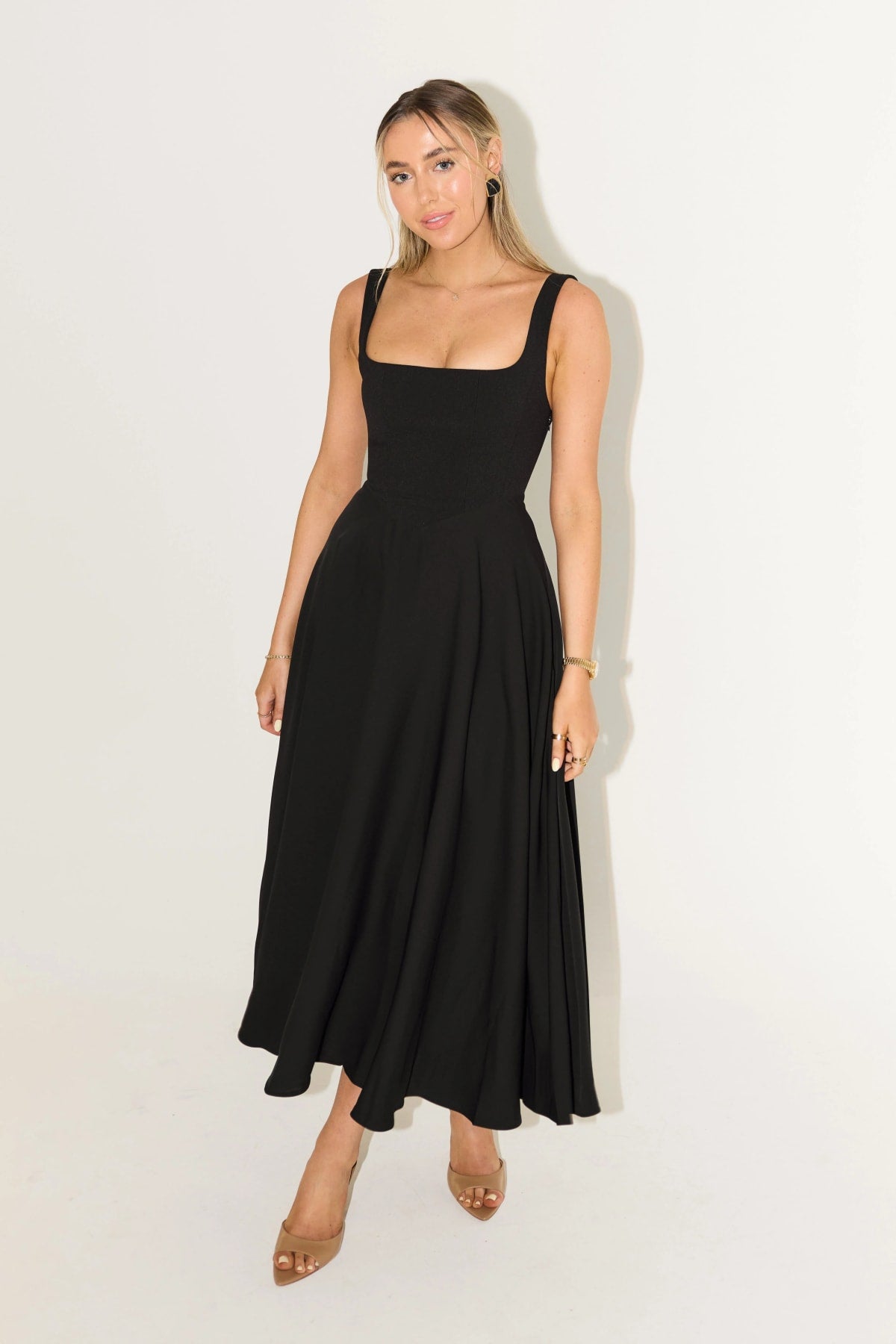 Square neck midi dress with waist-defining fit and flowing skirt.
