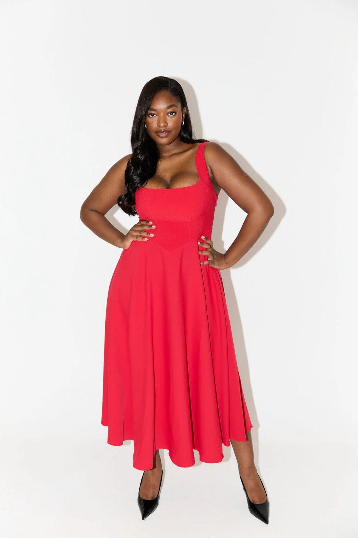 Square neck midi dress with waist-defining fit and flowing skirt.