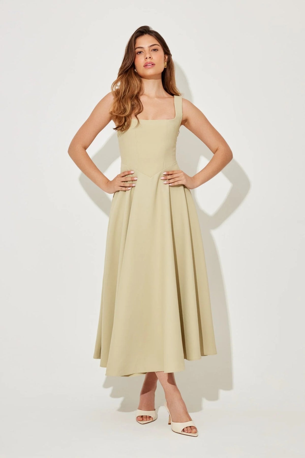 Square neck midi dress with waist-defining fit and flowing skirt.