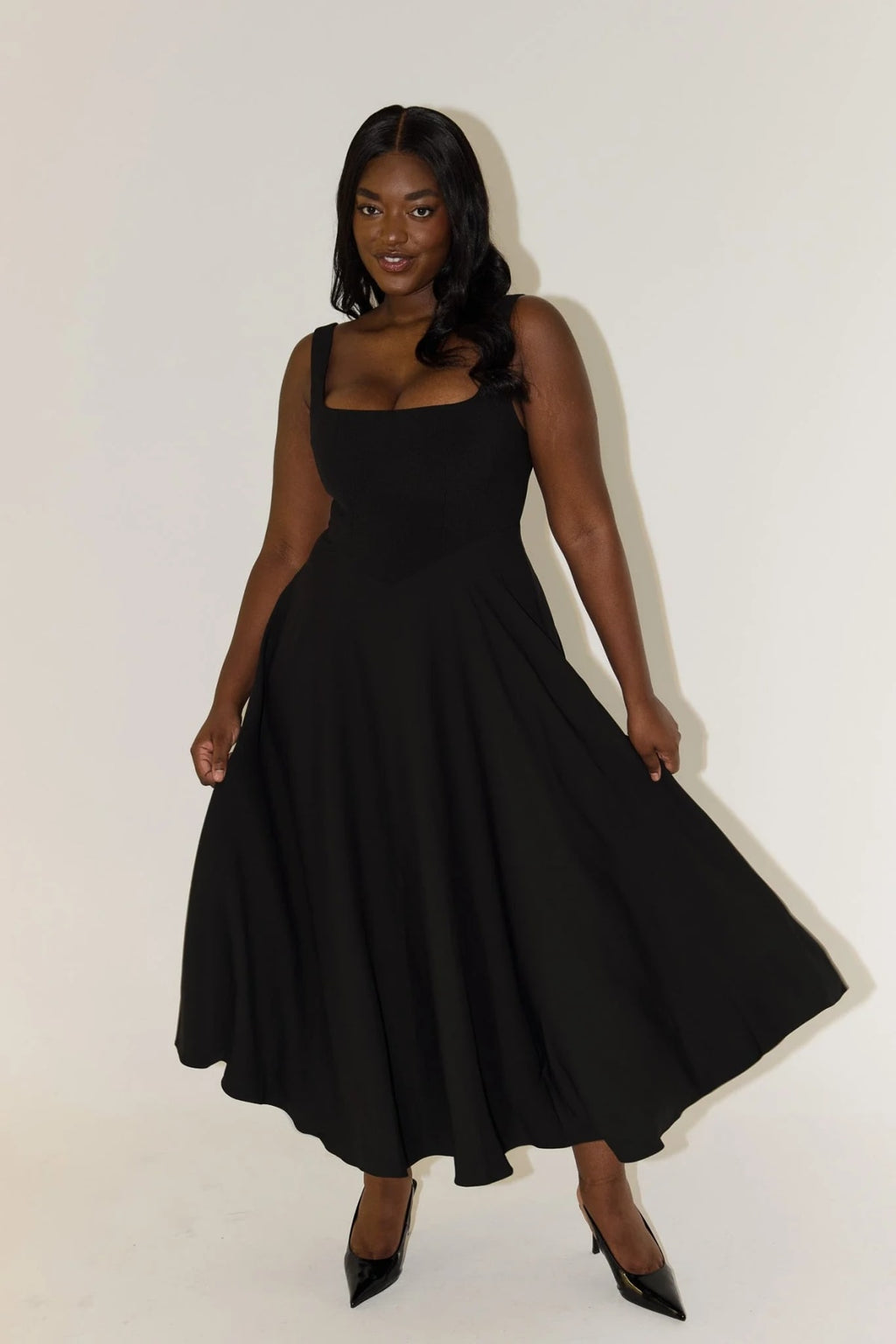 Square neck midi dress with waist-defining fit and flowing skirt.