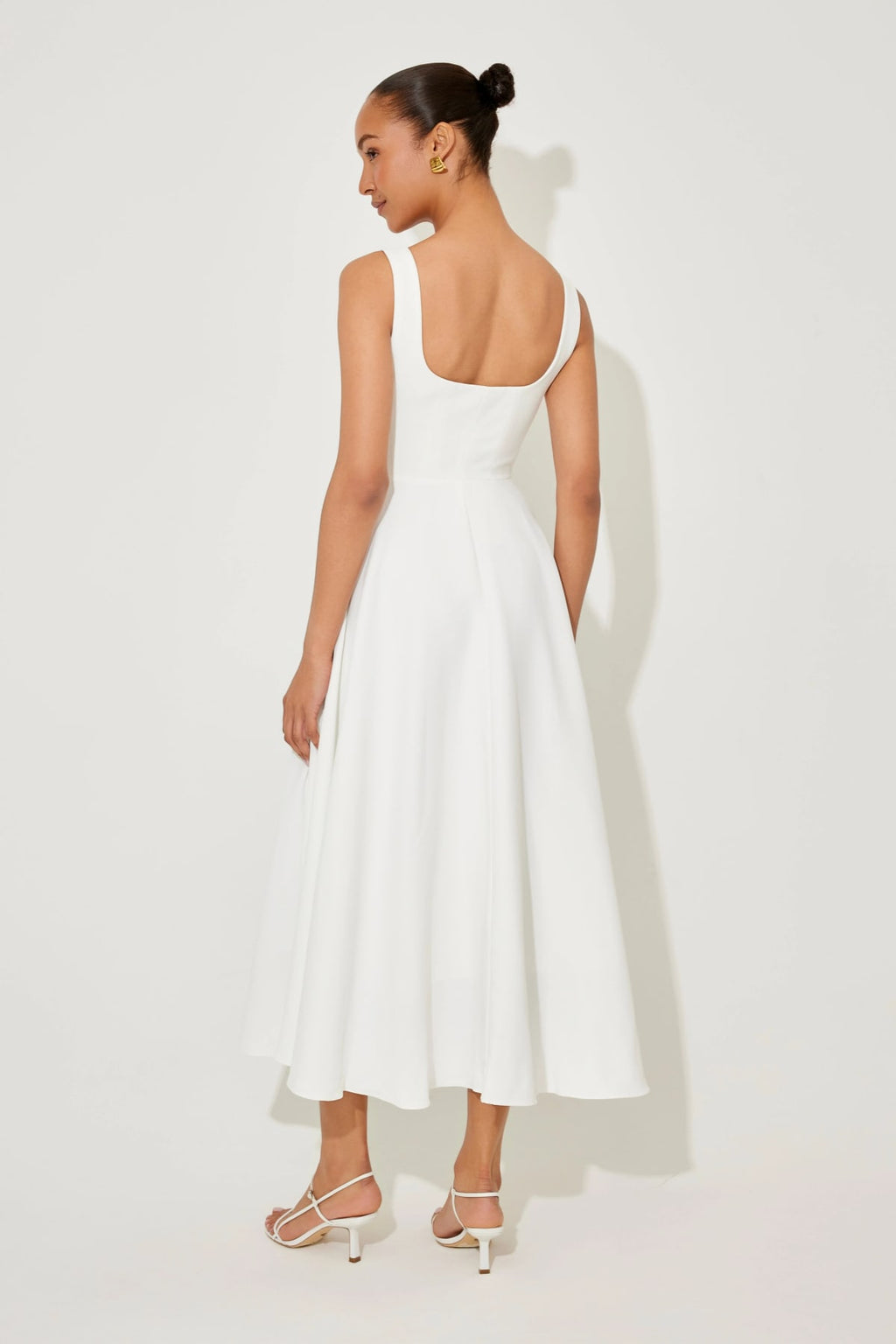 Square neck midi dress with waist-defining fit and flowing skirt.