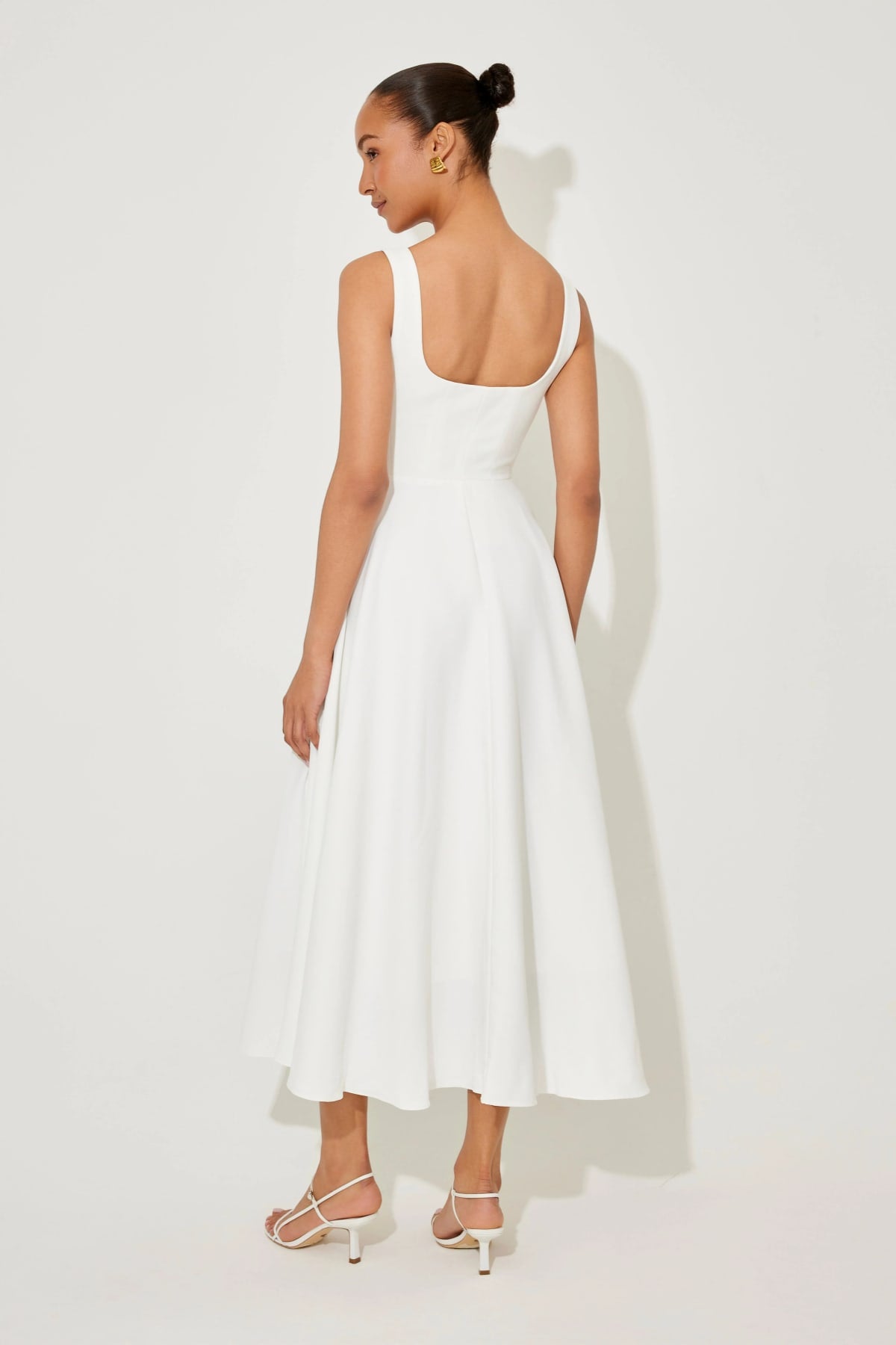 Square neck midi dress with waist-defining fit and flowing skirt.