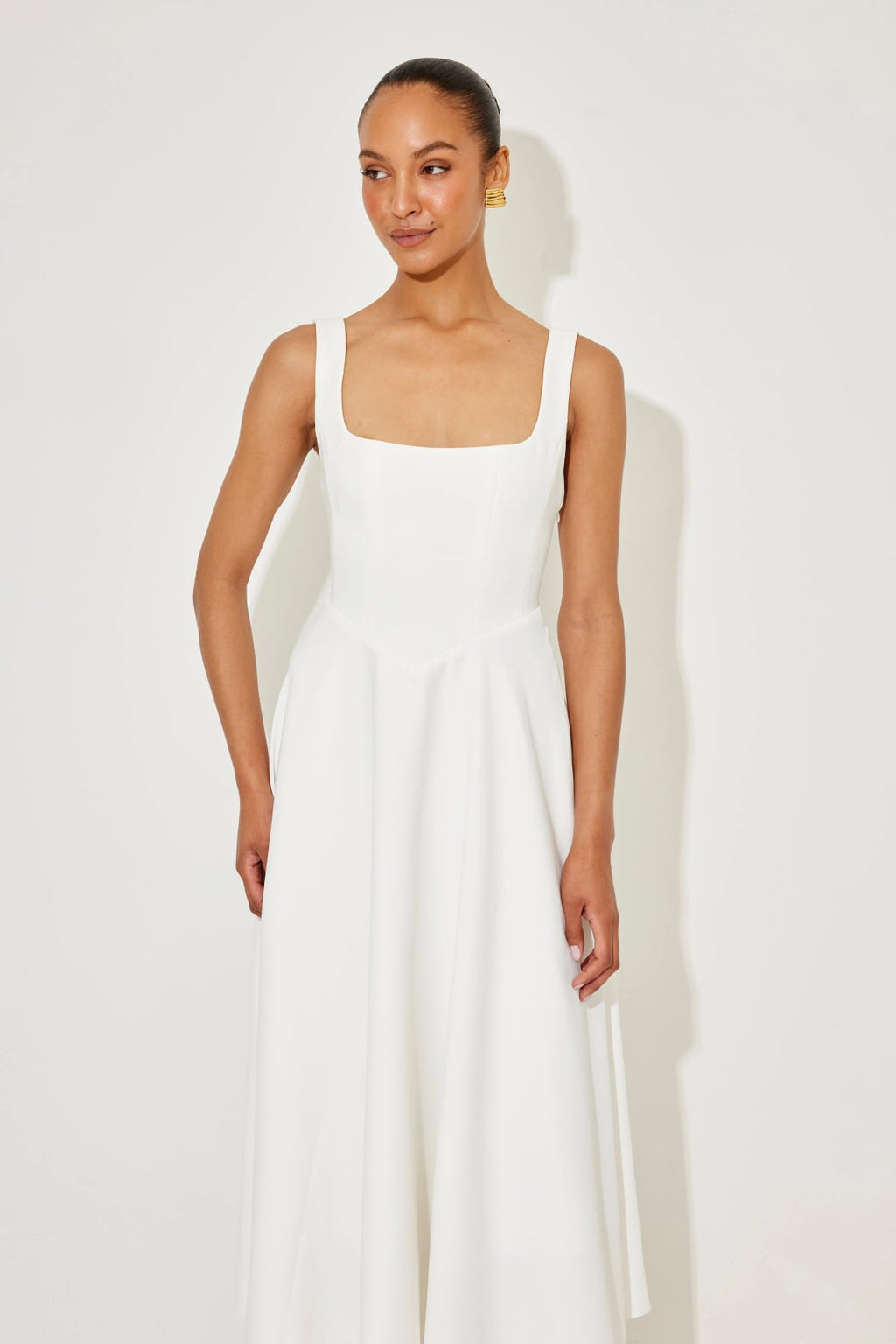 Square neck midi dress with waist-defining fit and flowing skirt.