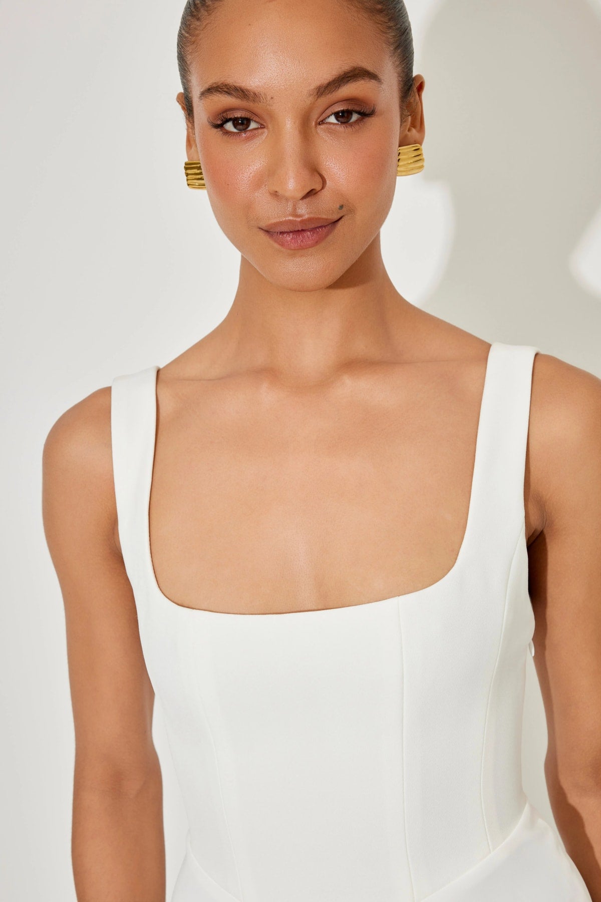 Square neck midi dress with waist-defining fit and flowing skirt.