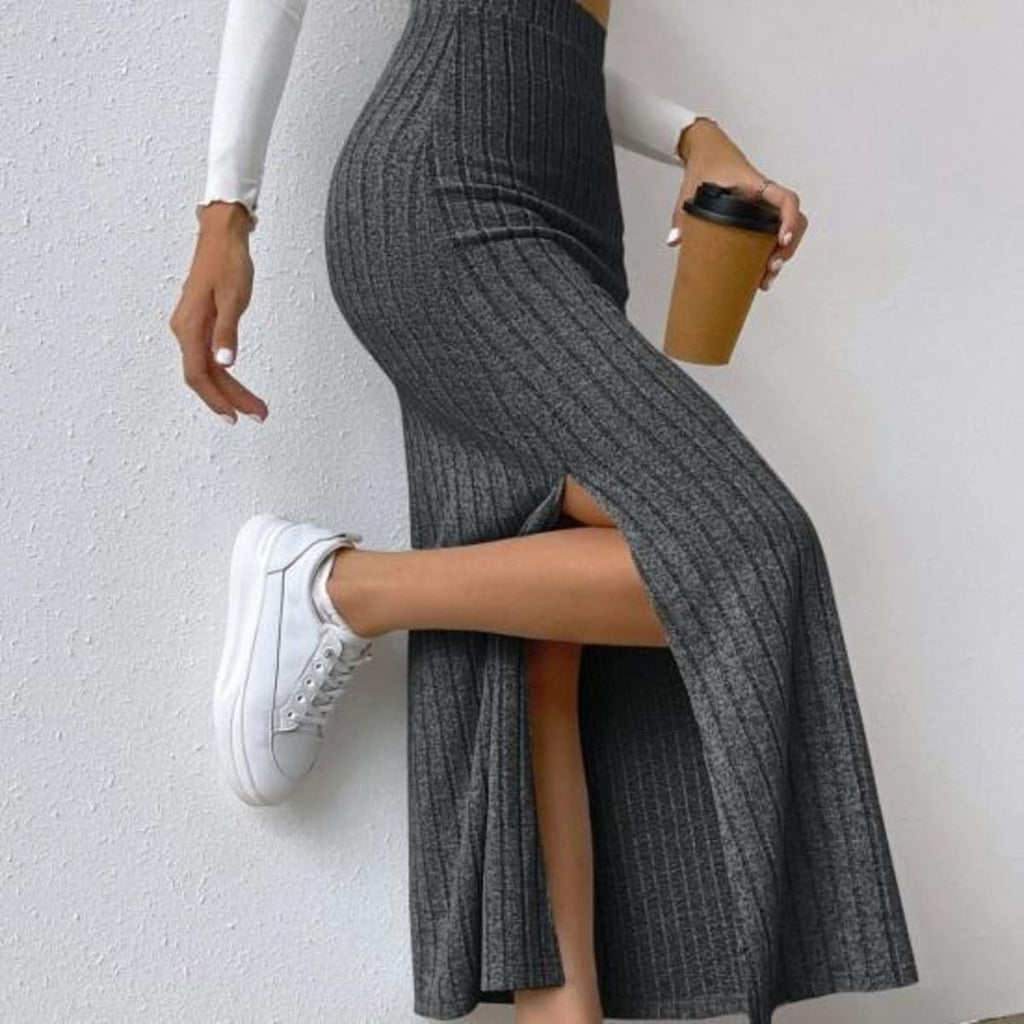 Woman wearing ribbed knit maxi skirt with a side slit.