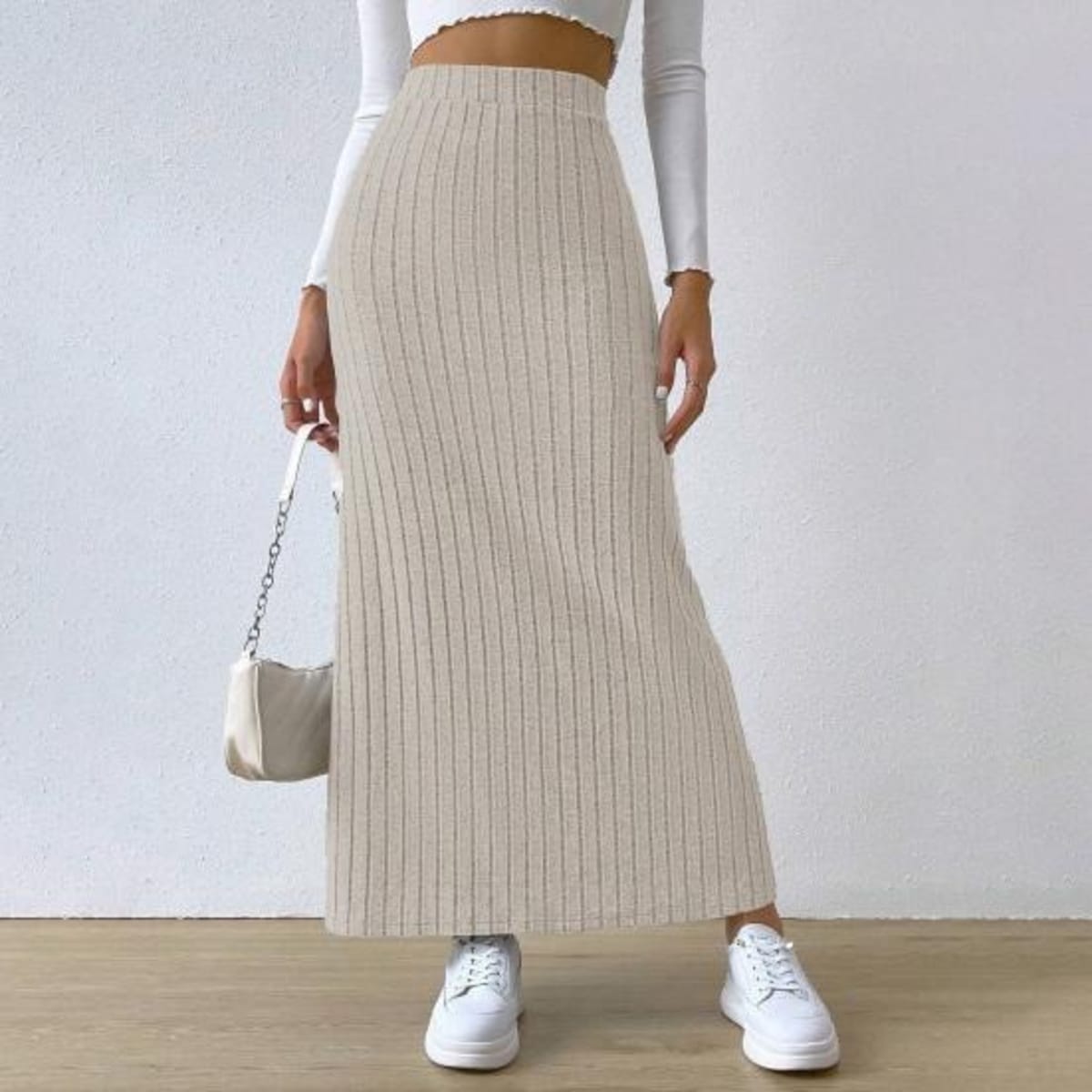 Woman wearing ribbed knit maxi skirt with a side slit.