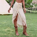 Cream midi skirt with fringe trim and high slit.