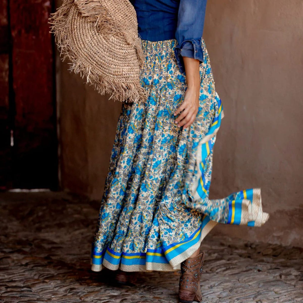 Woman wearing floral high-low maxi skirt with crochet top and sandals