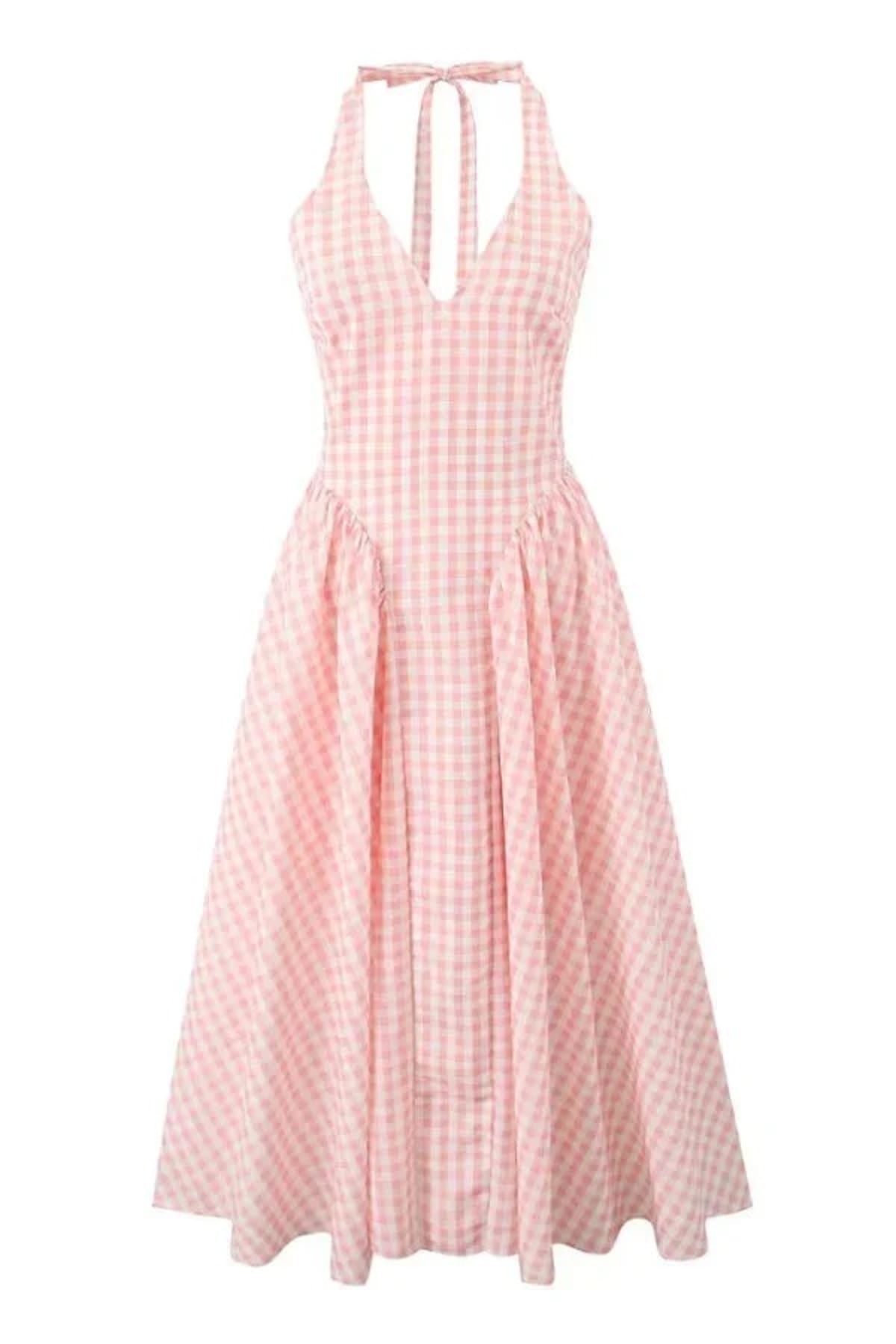 Woman wearing a gingham midi dress with V-neck and pleated skirt.