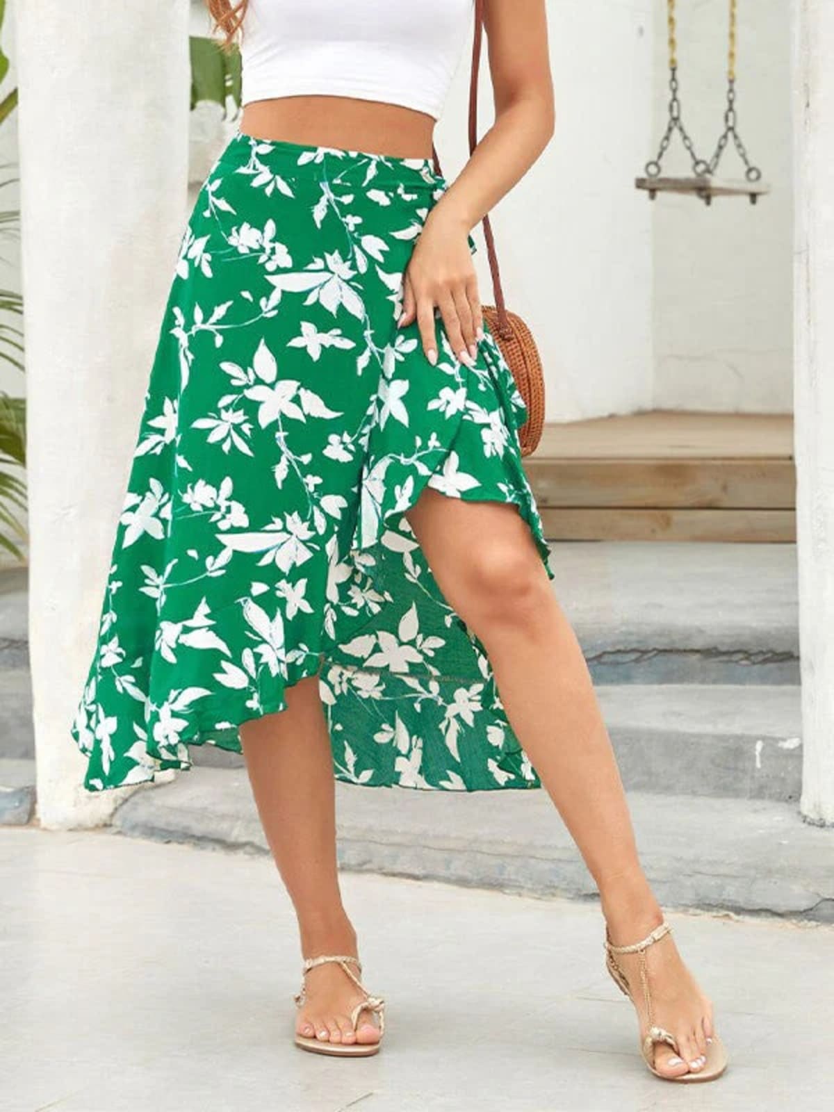 Woman wearing a floral wrap midi skirt with ruffled hem.