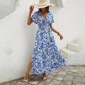 Flowy beach dress with V-neckline and subtle pattern.