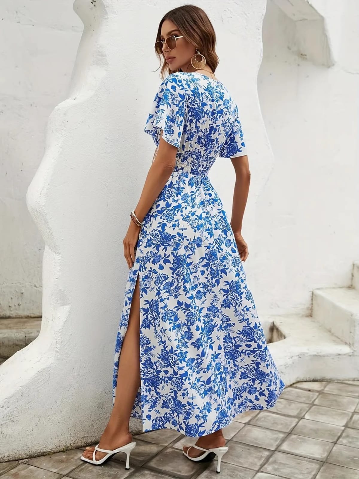 Flowy beach dress with V-neckline and subtle pattern.