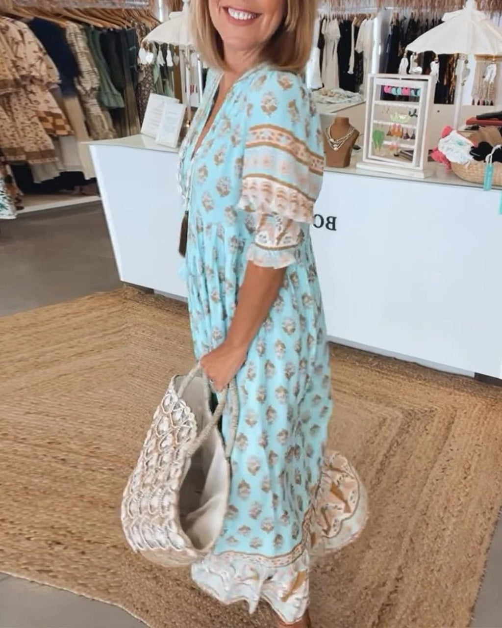 Boho midi dress with tassels and a flowing silhouette.
