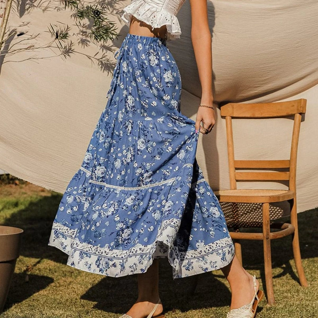 Woman wearing floral tiered maxi skirt with patterned hem outdoors