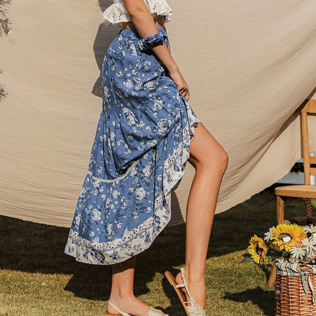 Woman wearing floral tiered maxi skirt with patterned hem outdoors