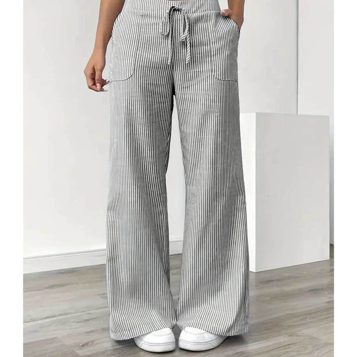 Striped pants with adjustable waistband and pockets for women.