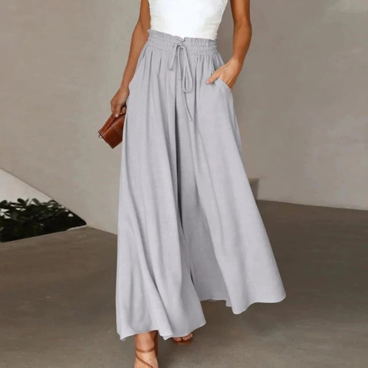 High-waisted wide-leg pants with smocked waistband and drawstring.