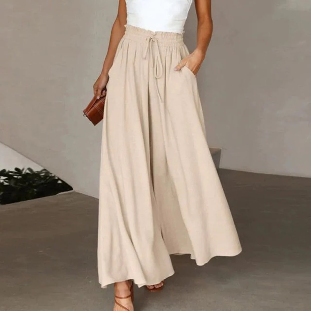 High-waisted wide-leg pants with smocked waistband and drawstring.