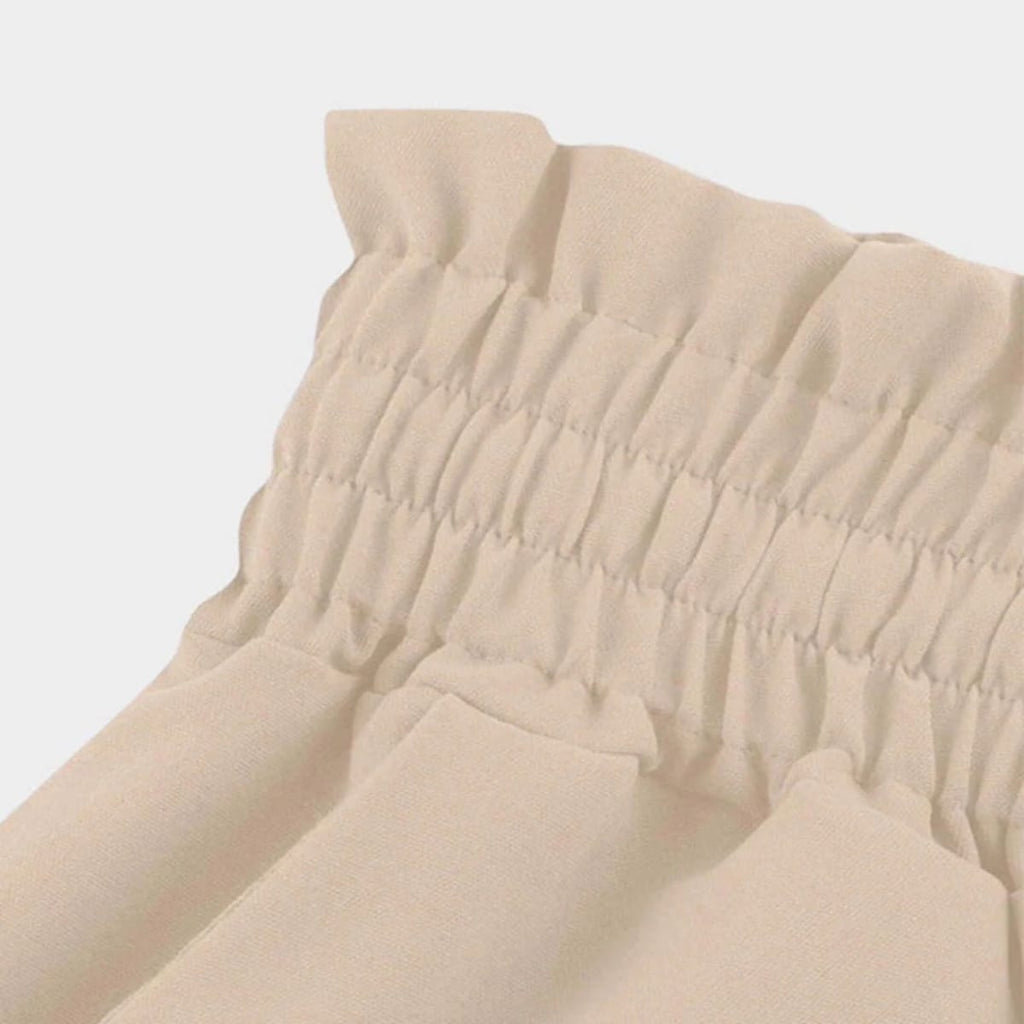 High-waisted wide-leg pants with smocked waistband and drawstring.