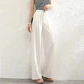 Women's high-waisted wide-leg pants with button closure.