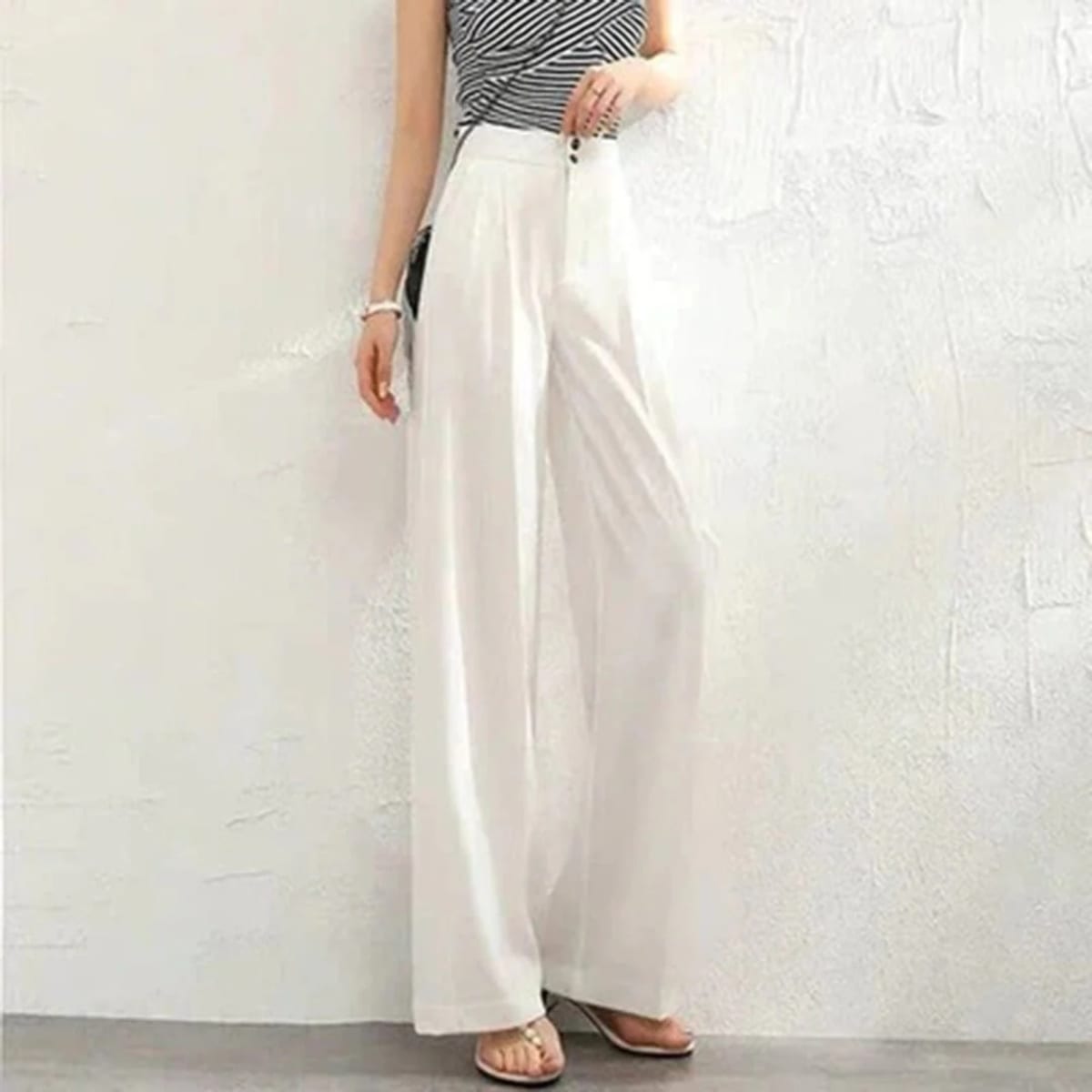 Women's high-waisted wide-leg pants with button closure.
