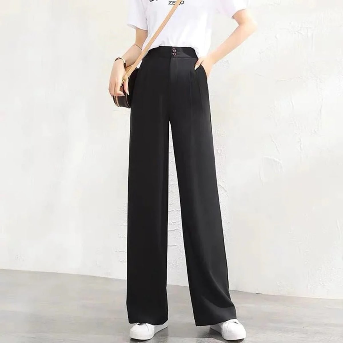 Women's high-waisted wide-leg pants with button closure.