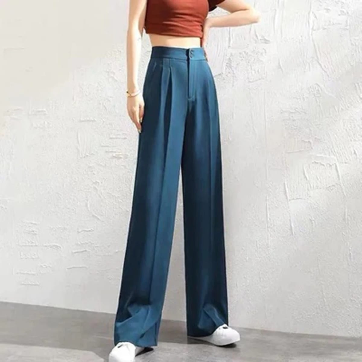 Women's high-waisted wide-leg pants with button closure.